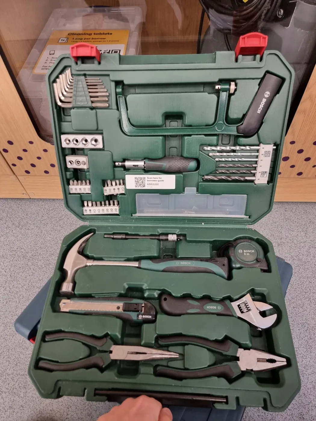Open tool case with drivers, pliers and fittings