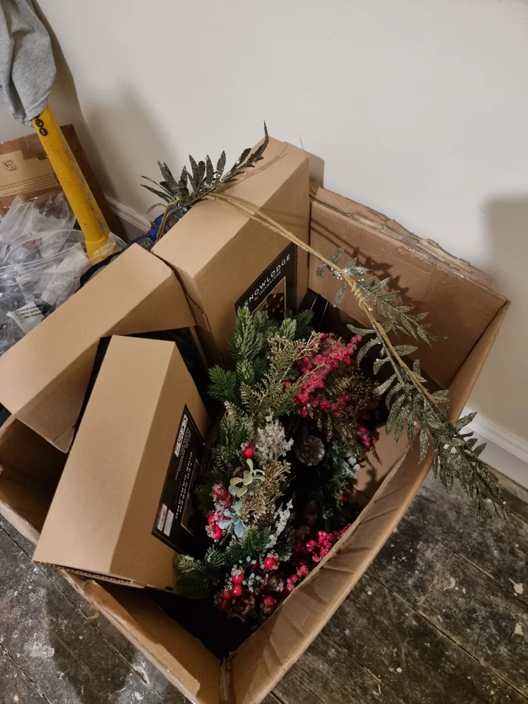Box of wreaths and garlands unpacked before an installation