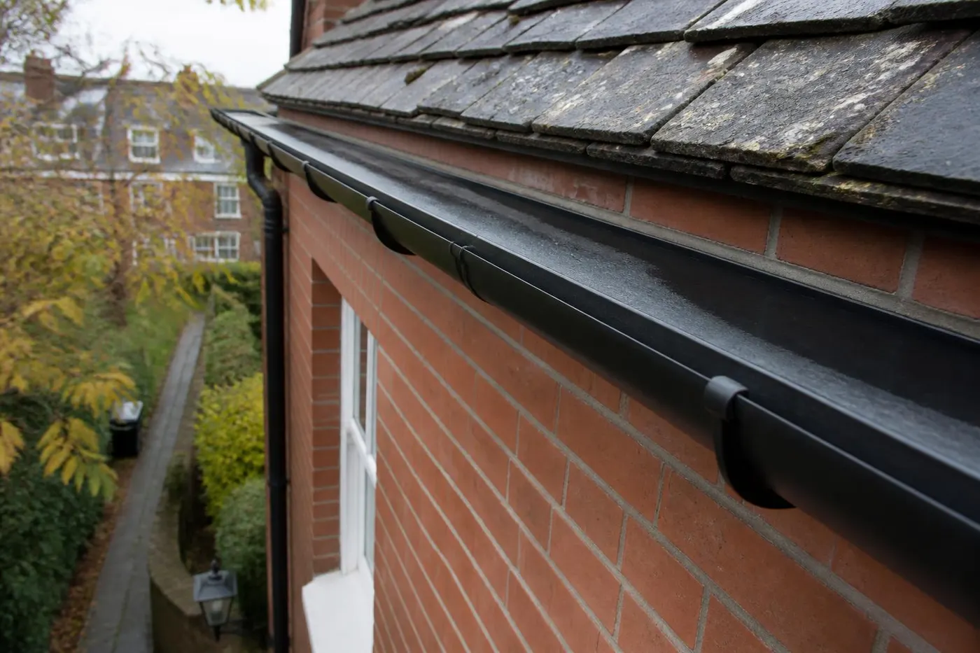 The same style of gutter cleared, dry and running freely after clearing